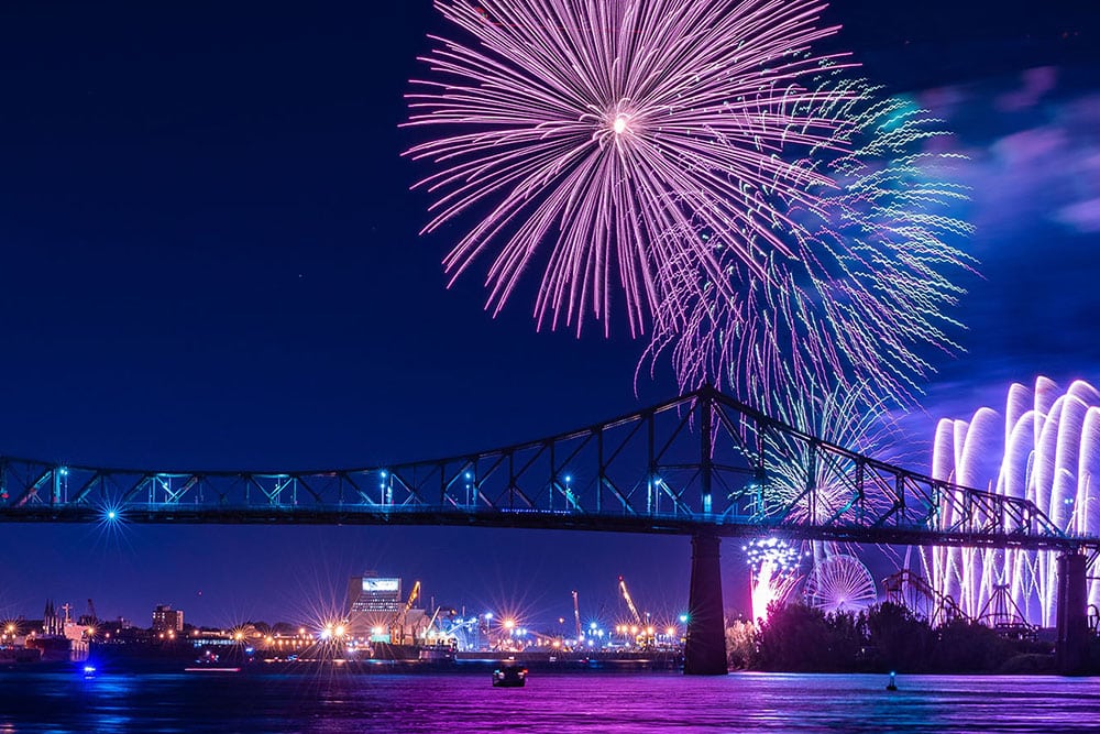 View of Montreal bridge at night with fireworks in the background